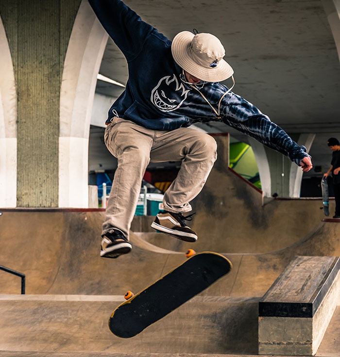 Skateboarder performing a mid-air trick in an urban skatepark, capturing action and movement for doctors second opinion stories.