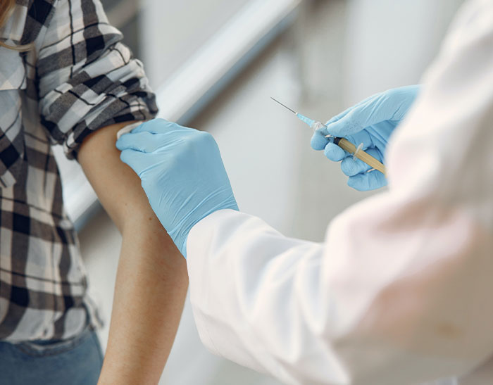 Doctor wearing gloves preparing to give an injection to patient illustrating doctors second opinion stories.