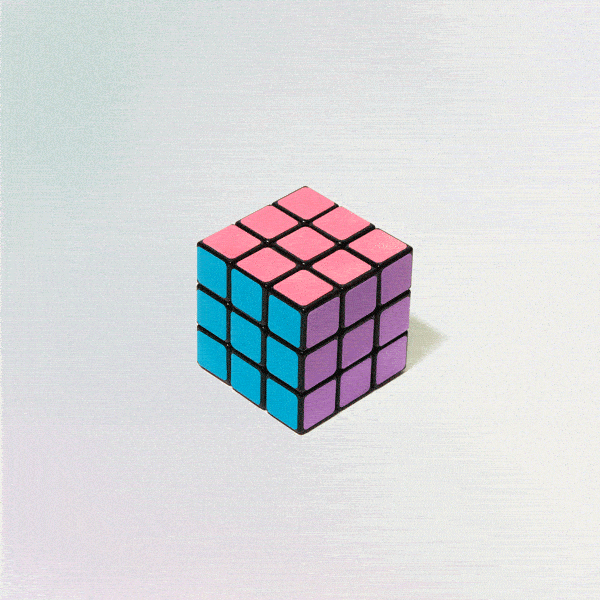 Colorful Rubik's Cube rotating on a white surface, showcasing unusual and conceptual product design creativity.