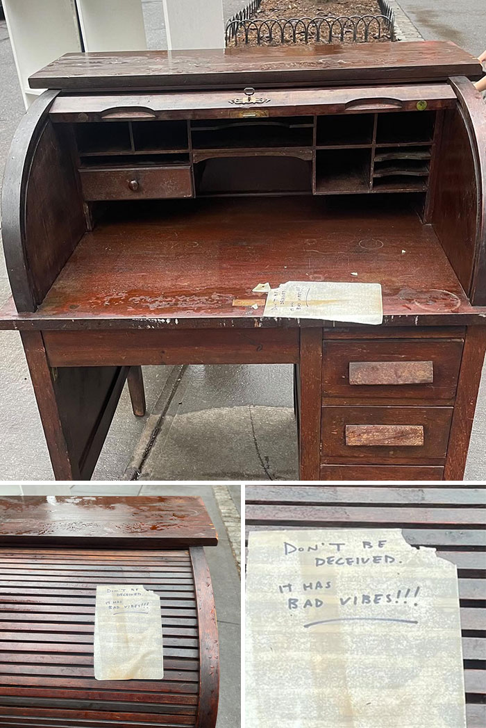 Old wooden roll-top desk found discarded on the street with a note warning it has bad vibes, one man's trash treasure.