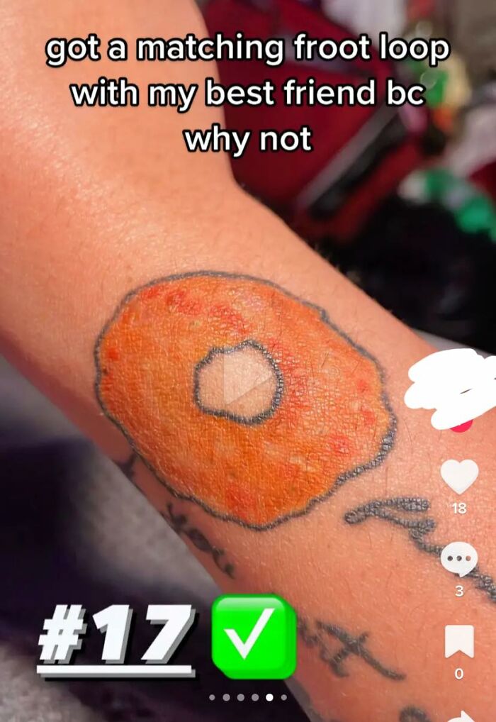 Bad tattoo of a Froot Loop cereal piece on an arm with humorous intent.