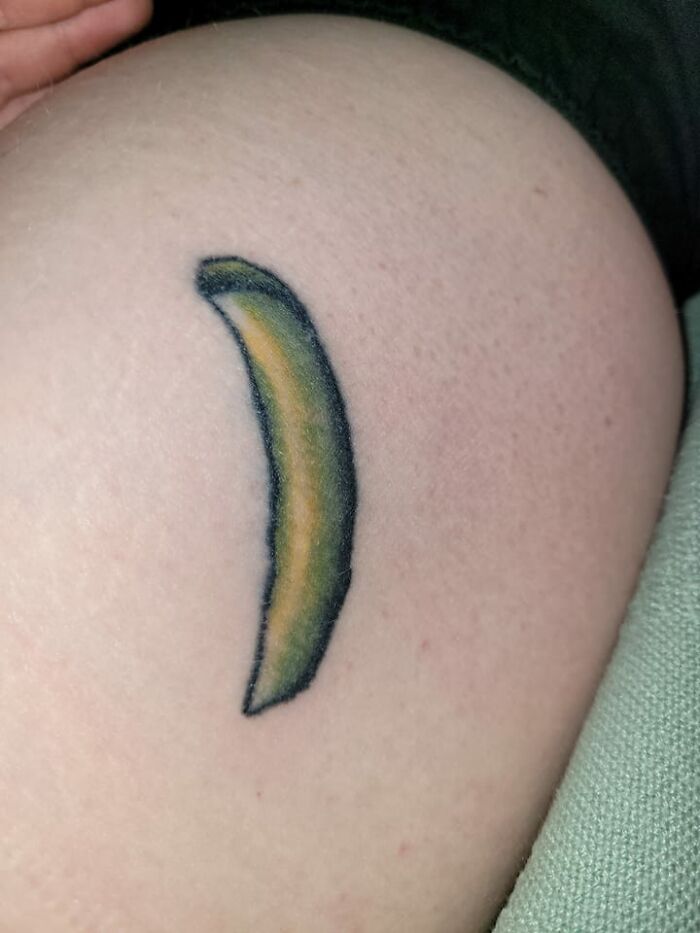 Poorly drawn banana tattoo on skin, representing hilariously bad tattoos.