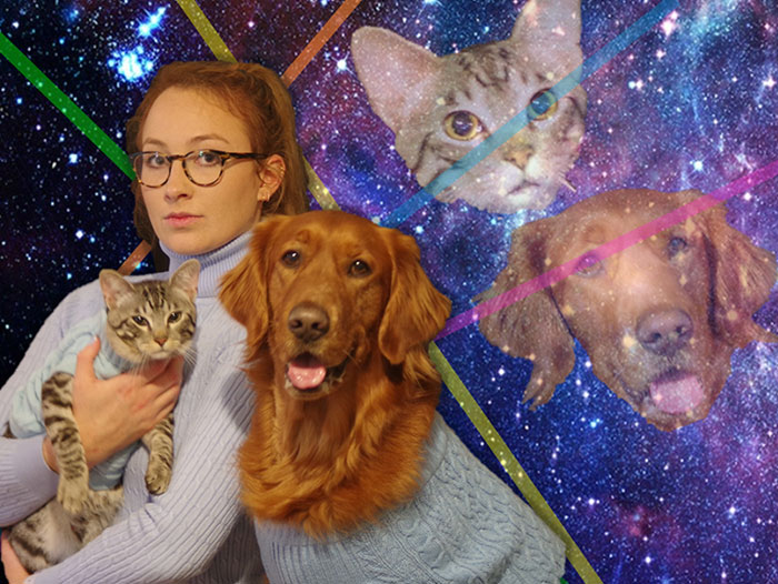 Person in blue sweater posing with cat and dog, cosmic background; humorous and amusing Christmas photo.