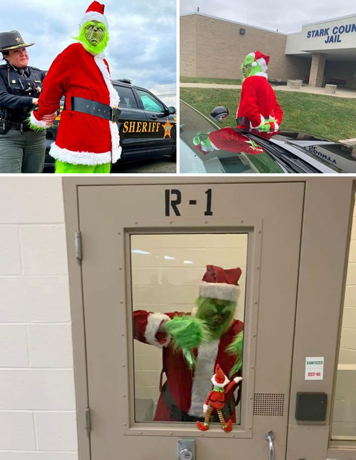Grinch in Santa outfit humorously arrested, posing in jail cell for a playful Christmas scene.