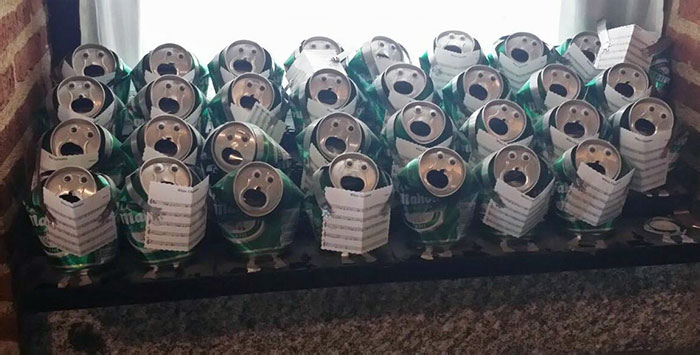 Humorous Christmas display of crushed soda cans arranged as a choir, bringing amusement to the festive season.