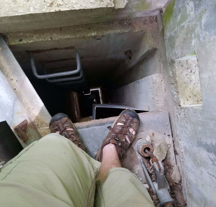 Found This Big Structure Hiking In The Woods. Big Square Cement Tower, About 3 Stories Tall, Inside Had Metal Ladder To The Top With A Small Seat And Window. What Is?