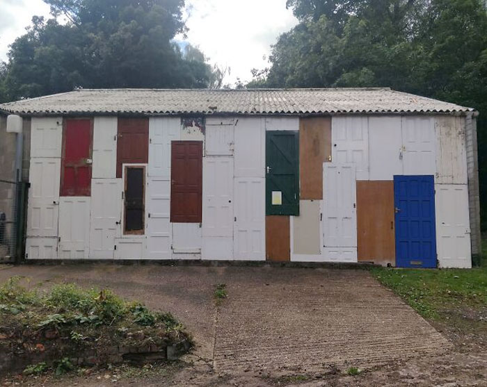 Walking In The Woods And Came Across This Building With A Whole Wall Made From Old Wooden Doors