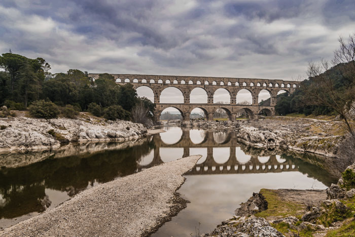 Pont Du Gard bridge near forest and rocks