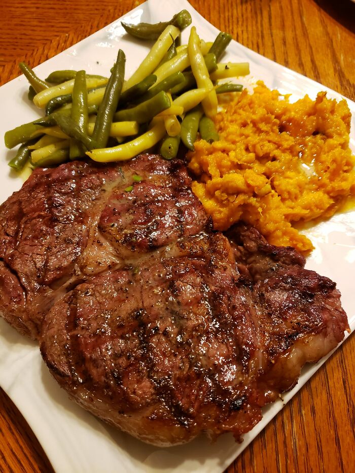 Grilled steak with green beans and mashed sweet potatoes, featured in a Facebook group rating others' dishes.