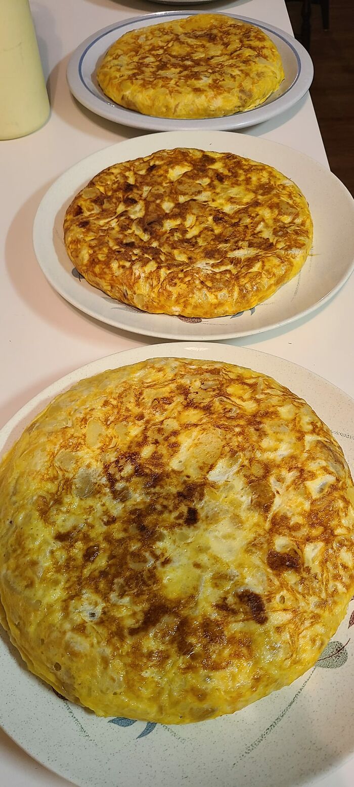 Three potato omelettes on plates, featured in a Facebook group where people rate others' dishes.