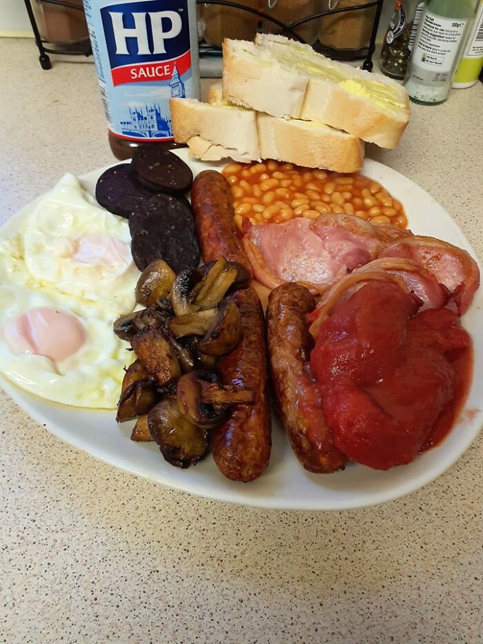 Full English breakfast with eggs, sausages, beans, mushrooms, toast, and HP sauce from a dish rating Facebook group.