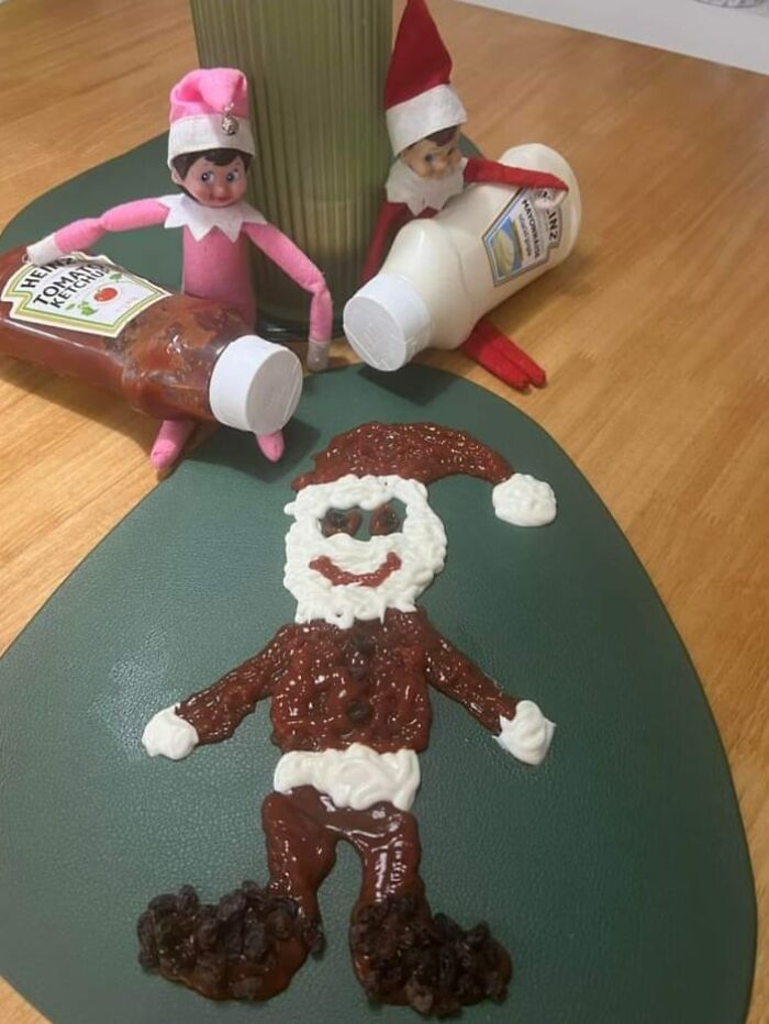 Two elf dolls pouring ketchup and mayonnaise to create a Santa figure on a placemat, rated in a Facebook group for dishes.
