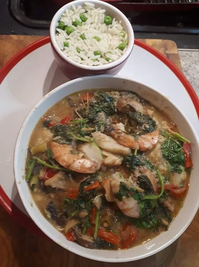 Shrimp and vegetable stew served with a side of rice and peas, featured in a dish rating Facebook group post.