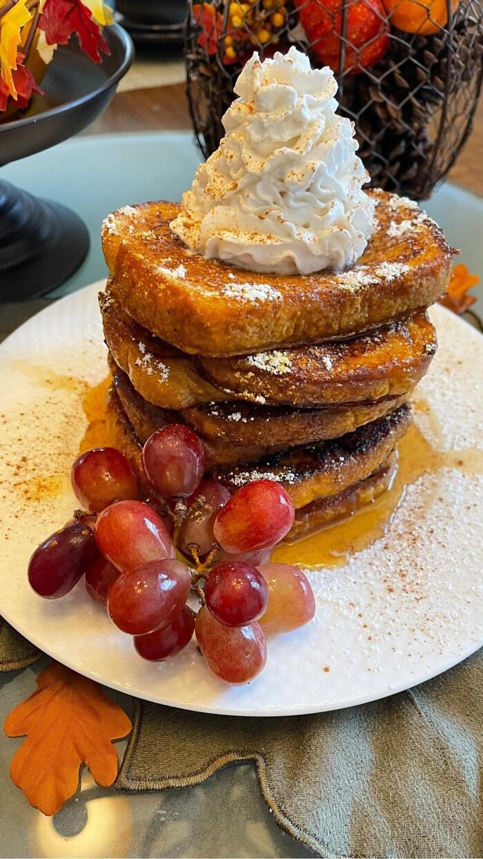 Stack of French toast with whipped cream, grapes, and syrup featured in a Facebook group where people rate others' dishes