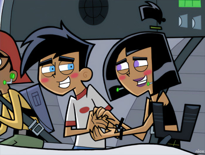 Cartoon couple smiling and holding hands inside a futuristic setting.