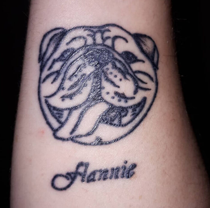 Tattoo of a dog with the name "Annie" below, showcasing pet-inspired ink art.