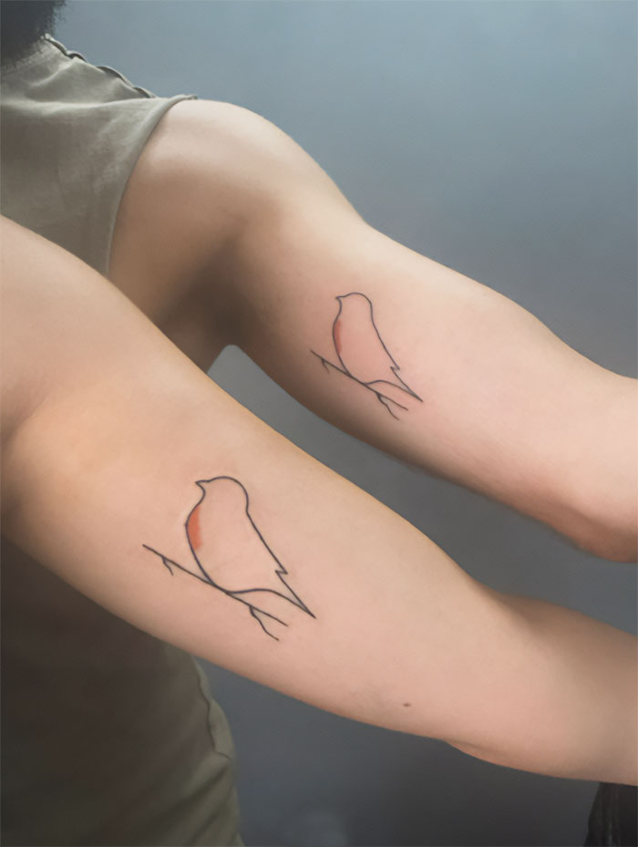 Minimalist bird tattoos on siblings' arms symbolizing brother and sister bond.