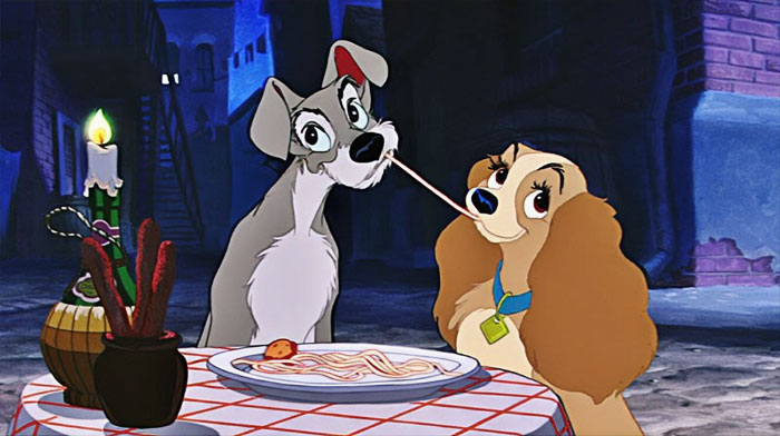 Cartoon couple sharing a romantic spaghetti dinner by candlelight.