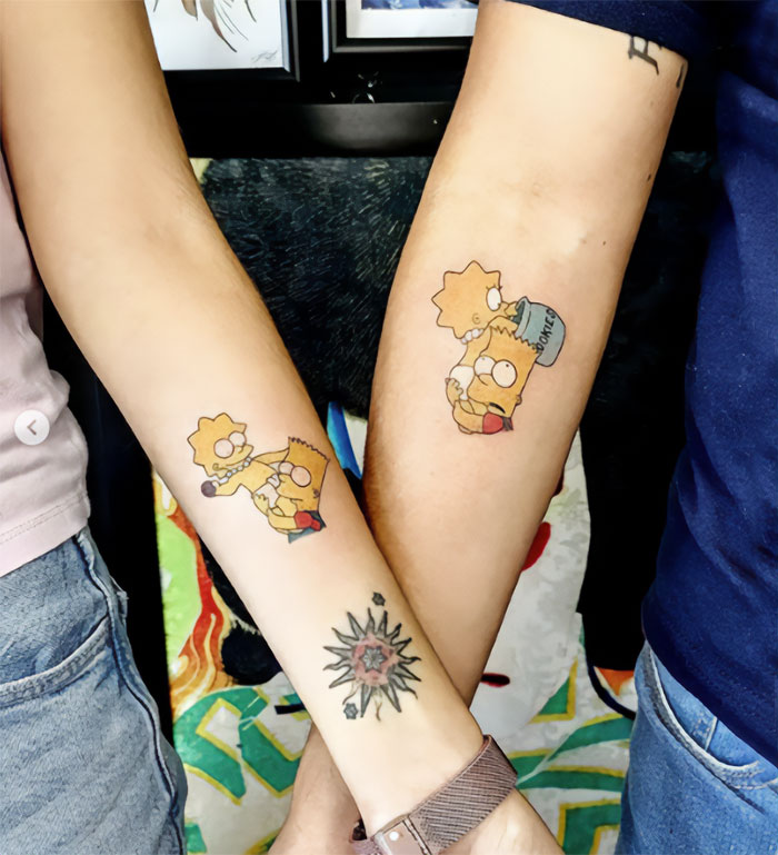 Brother and sister tattoos featuring cartoon characters on forearms, symbolizing sibling bond and connection.