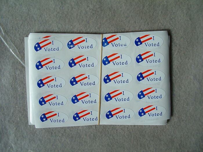 Sheets of I Voted stickers with American flag design, symbolizing good intentions and civic participation outcomes.