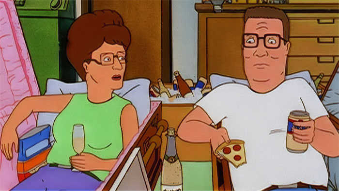 Cartoon couple enjoying pizza and drinks on the couch in a cozy setting, showcasing love sweeter than sugar.