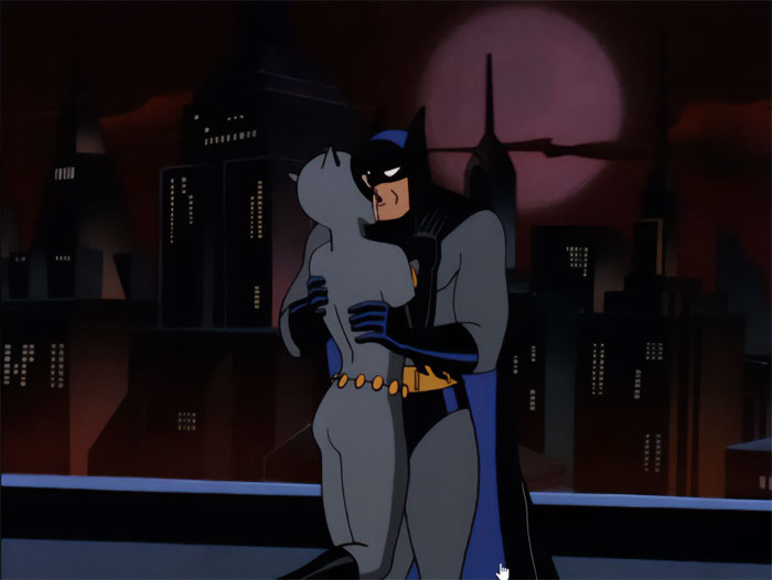 Cartoon couple in superhero costumes embracing on a rooftop at night with city skyline.