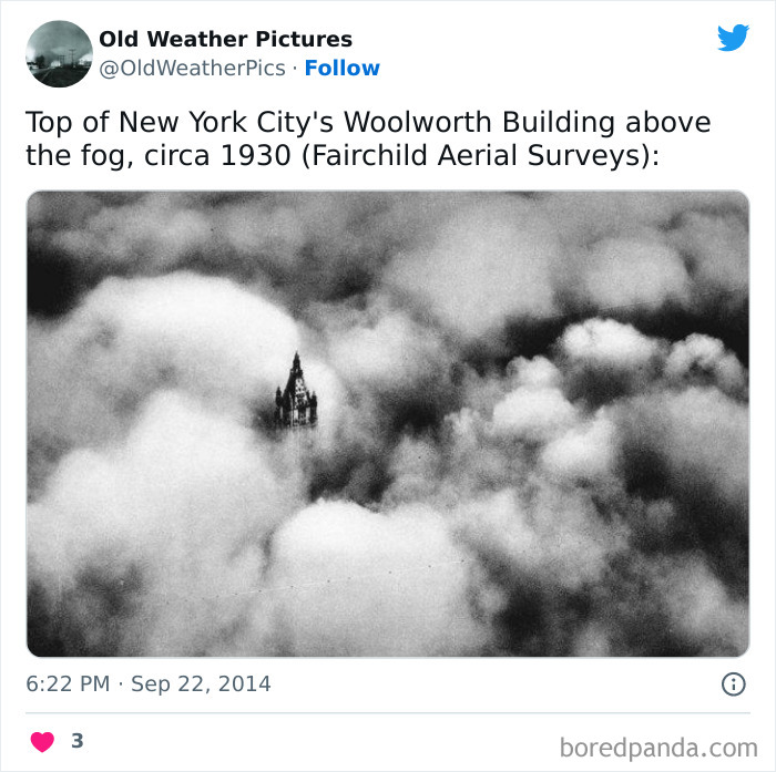 Top of New York City's Woolworth Building piercing through thick fog, an example of extreme and crazy weather in the past.