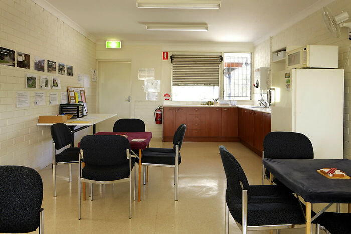 Empty community room with chairs and tables reflecting the road to hell is paved with good intentions concept