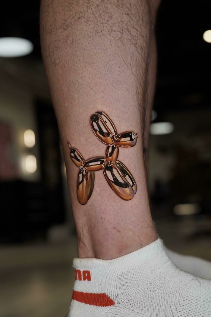 Beautiful tattoo of a balloon animal executed perfectly on a person's leg.