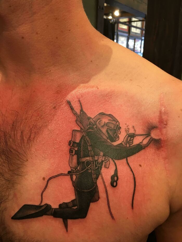 Diver tattoo on chest, showcasing a creative and perfectly executed tattoo idea.