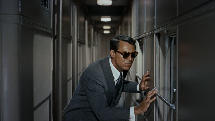 Roger looking at the window on the train 