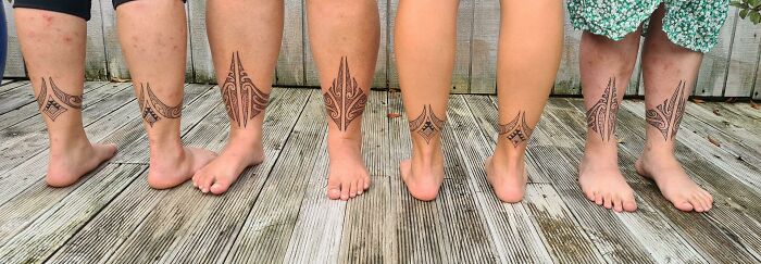 Five legs with matching geometric tattoos, perfect for simple brother and sister tattoo ideas.