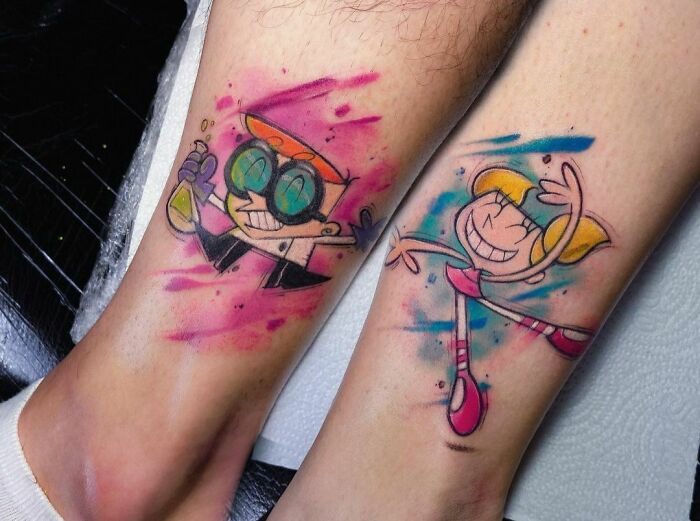 Colorful brother and sister tattoos of cartoon characters on legs.
