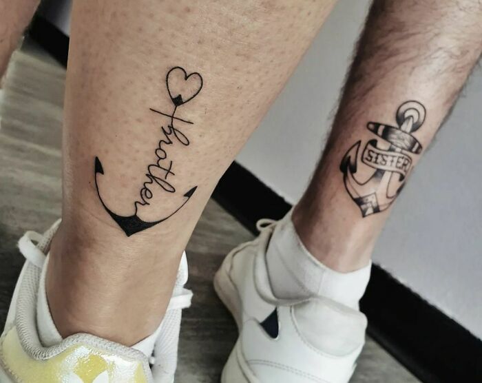 Brother and sister anchor tattoos on calves, showcasing a simple and meaningful design for siblings.