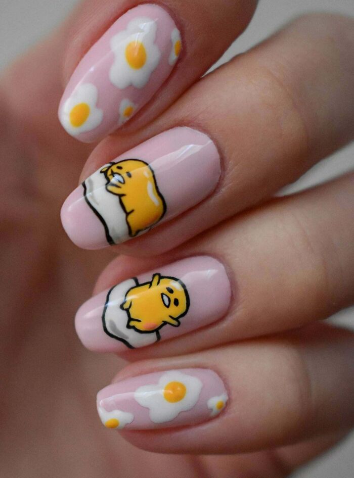Nail art ideas featuring pink nails with cute yellow chick and fried egg designs for creative tiny nail artworks.