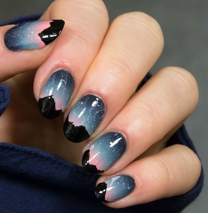 Starry night nail art design with mountain silhouettes, featuring a gradient of blue and pink hues; perfect for your next appointment.