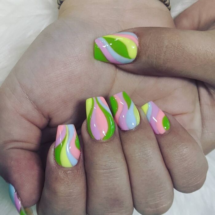 Colorful swirl nail art design, featuring vibrant green, pink, and blue patterns for your next nail appointment inspiration.