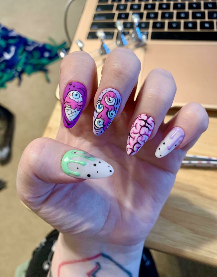 Nails featuring colorful and creative nail art designs with eyes, brain, and dripping patterns in pastel and bright colors.