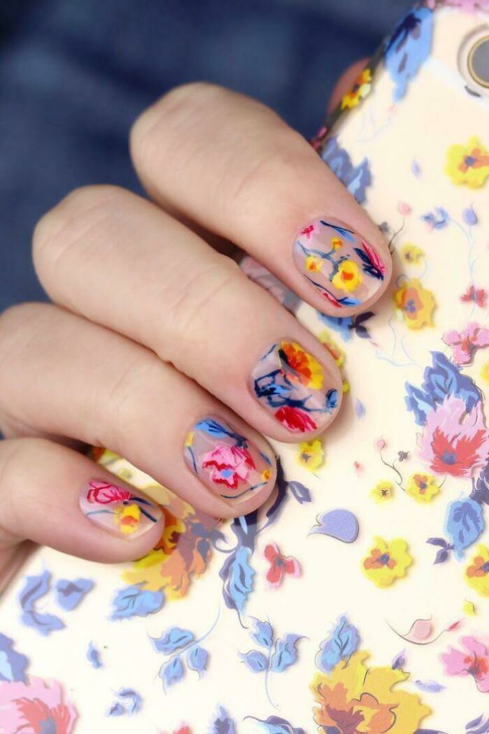 Floral nail art design with vibrant colors matching a floral phone case.