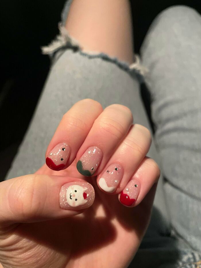 Hand close-up showing creative nail art with sparkling polish, colorful tips, and a cute animal design for nail art ideas.