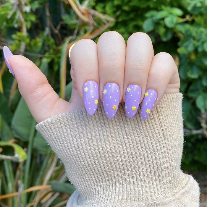 Purple nail art with star design, showcasing a creative idea for your next nail appointment.