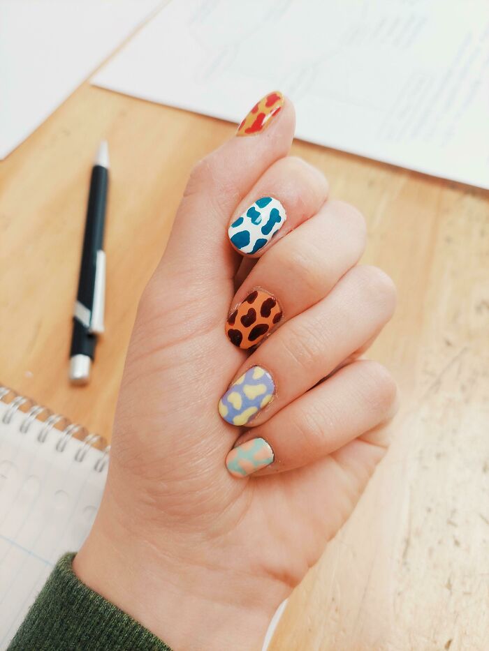 Colorful nail art designs showcasing vibrant patterns on each finger.