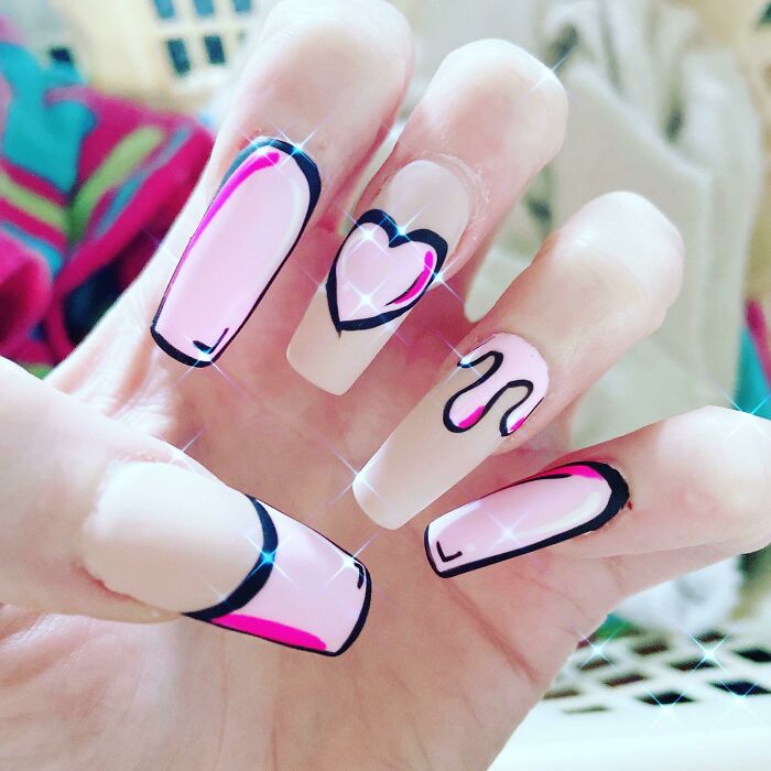 Pink and black abstract nail art design on long acrylic nails, featuring heart and swirl patterns. Perfect for nail art ideas.