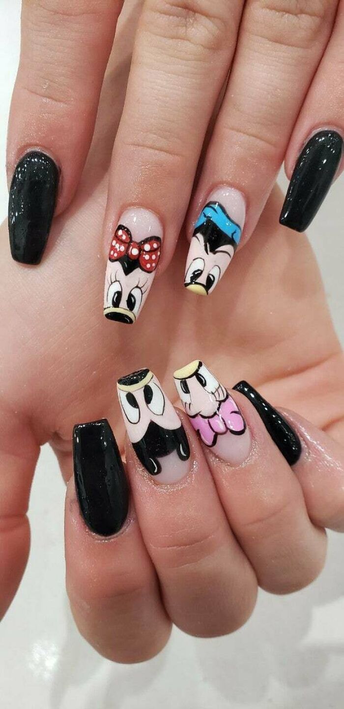 Black nails with detailed cartoon character nail art showcasing creative nail art ideas for unique nail designs.