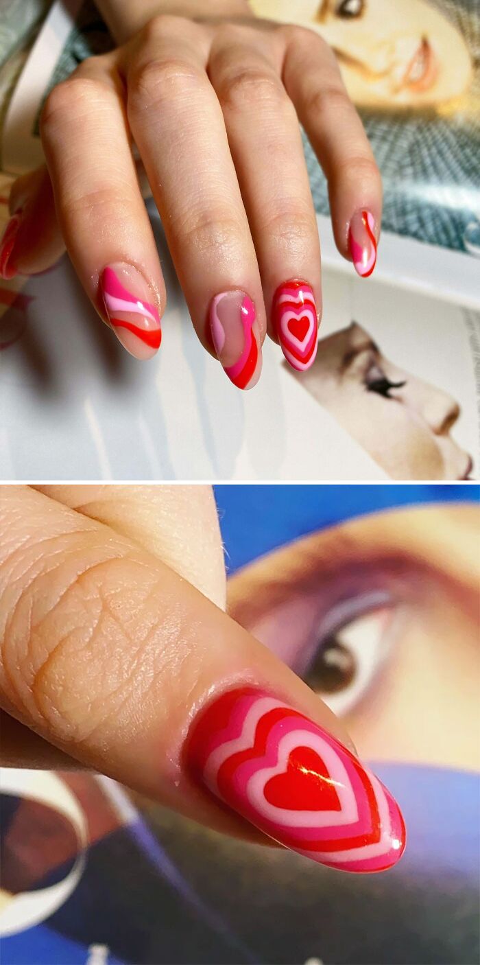 Close-up of colorful nail art featuring red and pink hearts and wavy patterns for creative nail art ideas.