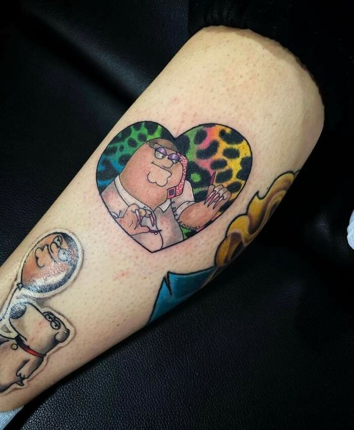 Tattoo featuring cartoon character inside a colorful heart, showcasing quality work with questionable design choices.