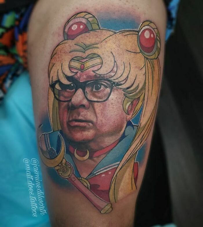 Tattoo with anime character's costume and a realistic face, blending humor and awkwardness in the design.