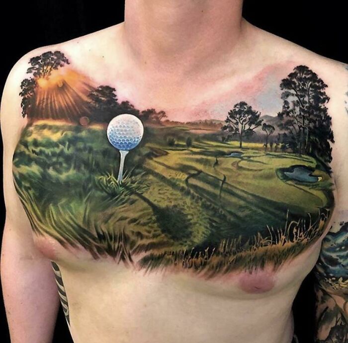 Quality tattoo with a golf course design on a man's chest.