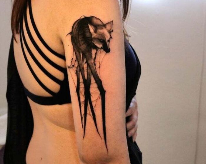 Trippy maned wolf tattoo on a person's arm, showcasing detailed artistic design.