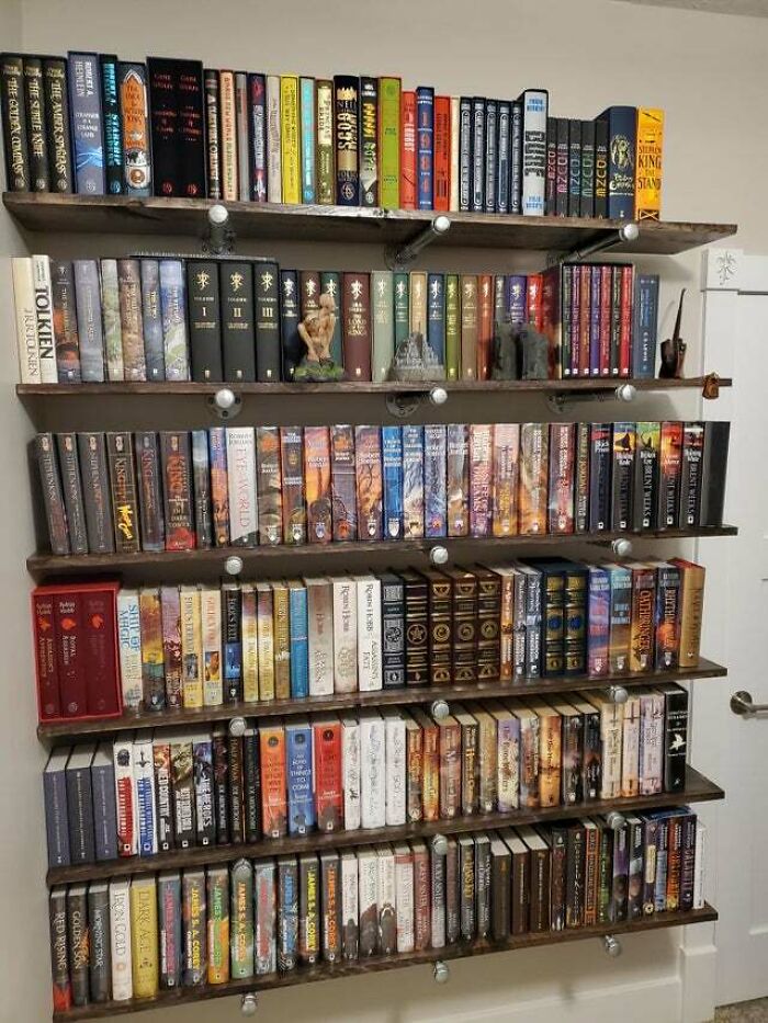 books and small figures on a bookshelf 